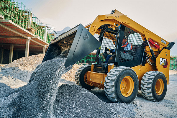 employee using Cat backhoe