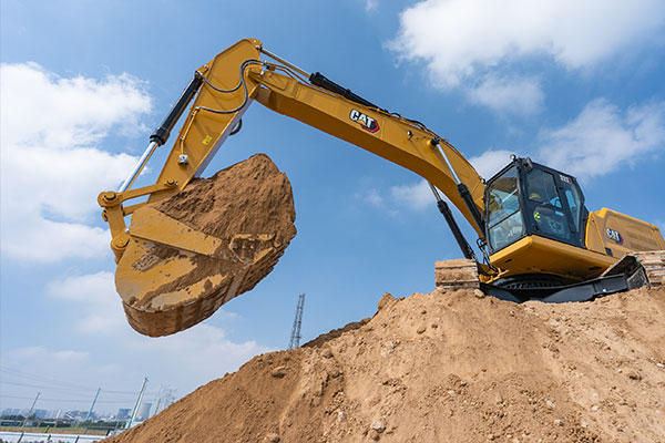 Cat excavator scooping dirt